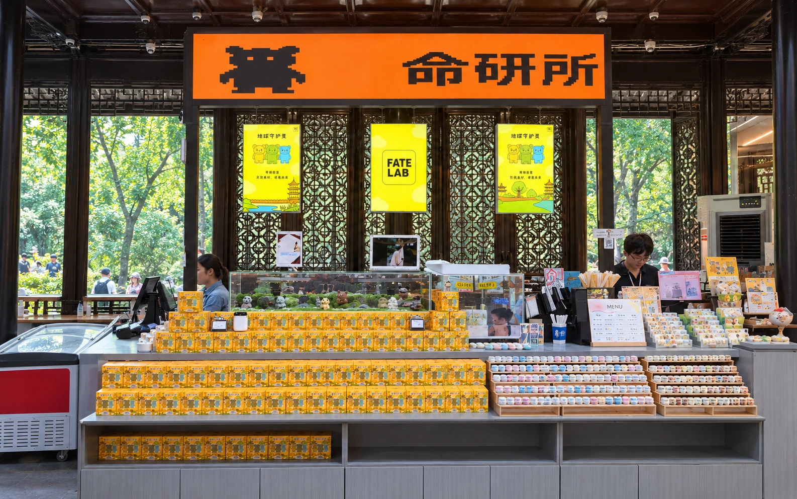 Front-facing FATELAB shop counter in Suzhou with Garden Guardians blind boxes, an iPad display and a freezer, framed by wooden lattice windows and garden greenery.